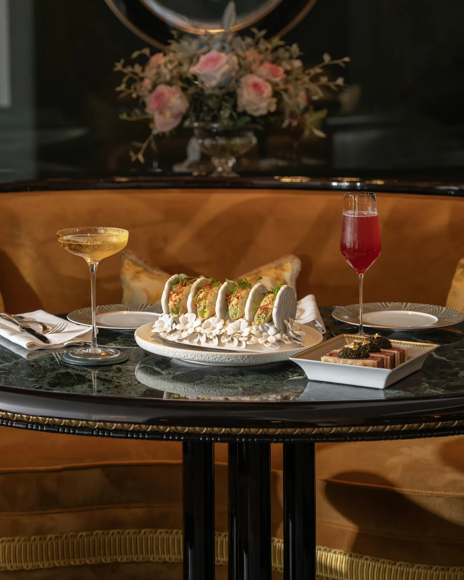 Cocktails and bar food arranged on a table at The Rivoli Bar